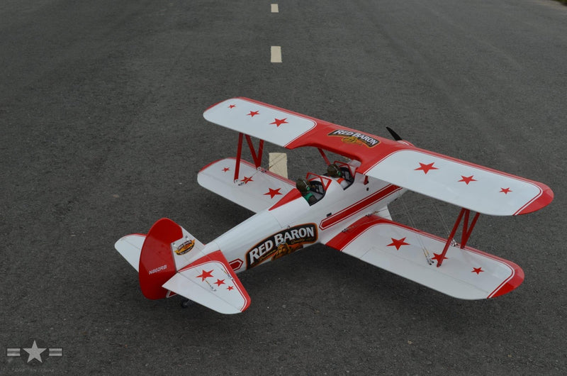 overhead view of the red and white red baron RC plane on a runway