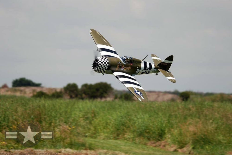 63" P-47G Thunderbolt Snafu 15cc flying at a tilt through the air over a green field